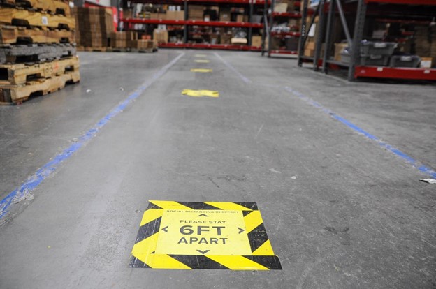 covid protection signs on the floor